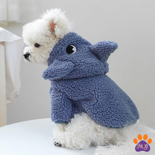 Small white dog wearing sherpa hooded coat